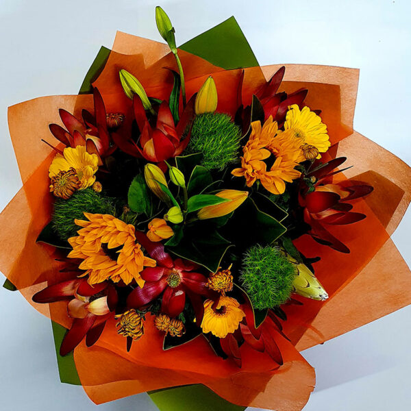 Bouquet in winter warm tones red yellow and orange